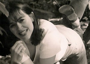 Kathy on stone ledge piece of grass in mouth 698 px W x 498 px H